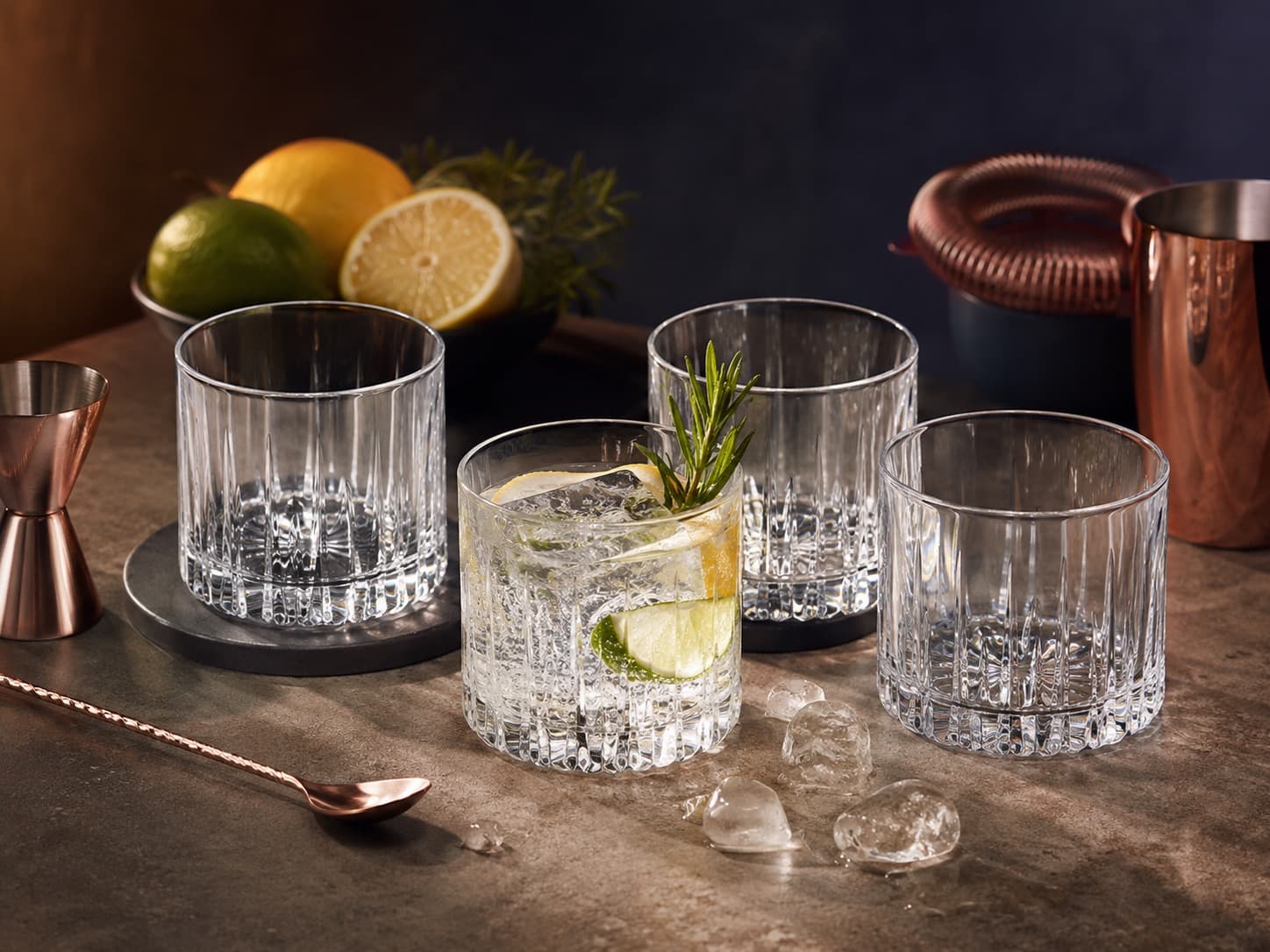 Old Fashioned Rocks Glasses Set of 4 arranged on a dark stone surface